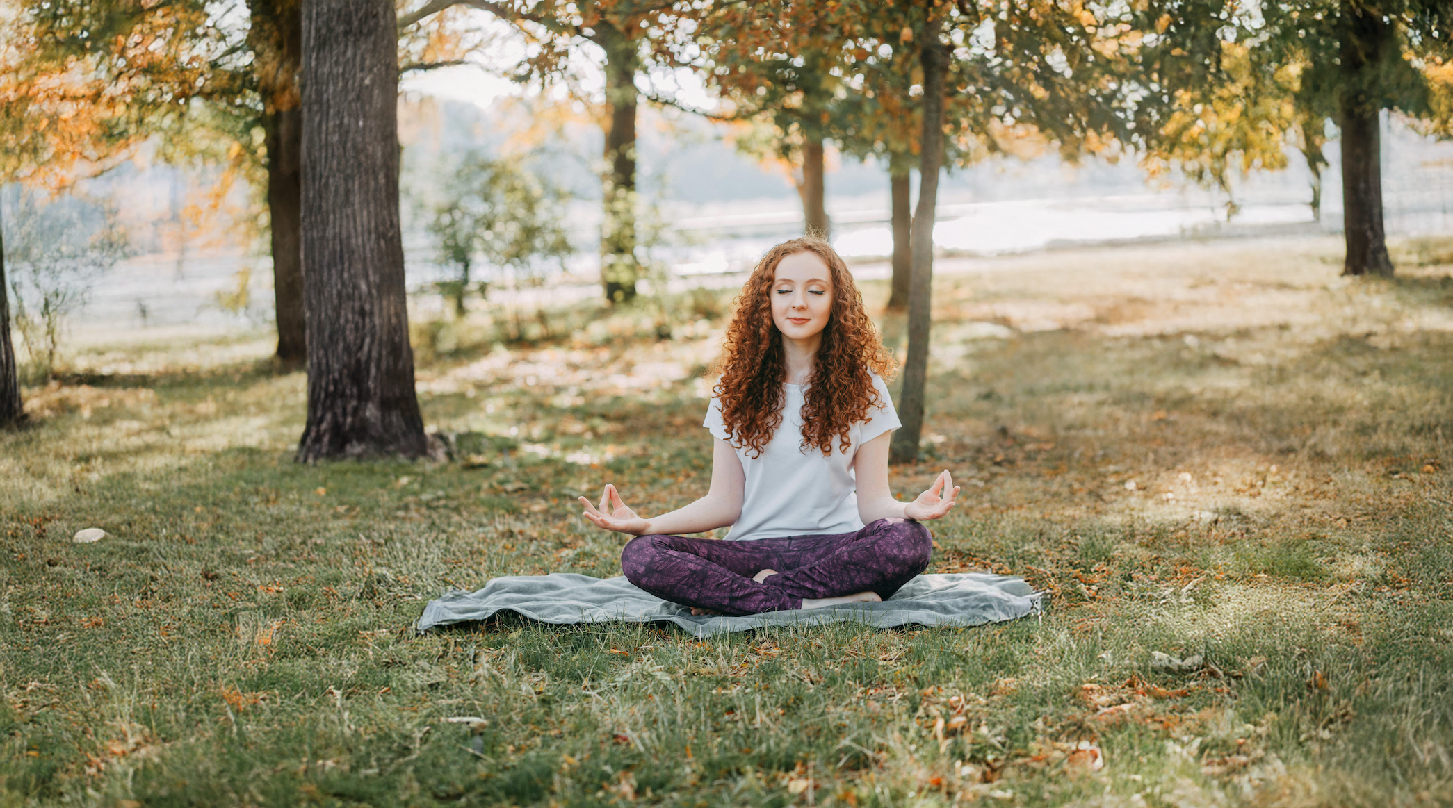 Person meditating peacefully in nature at sunrise